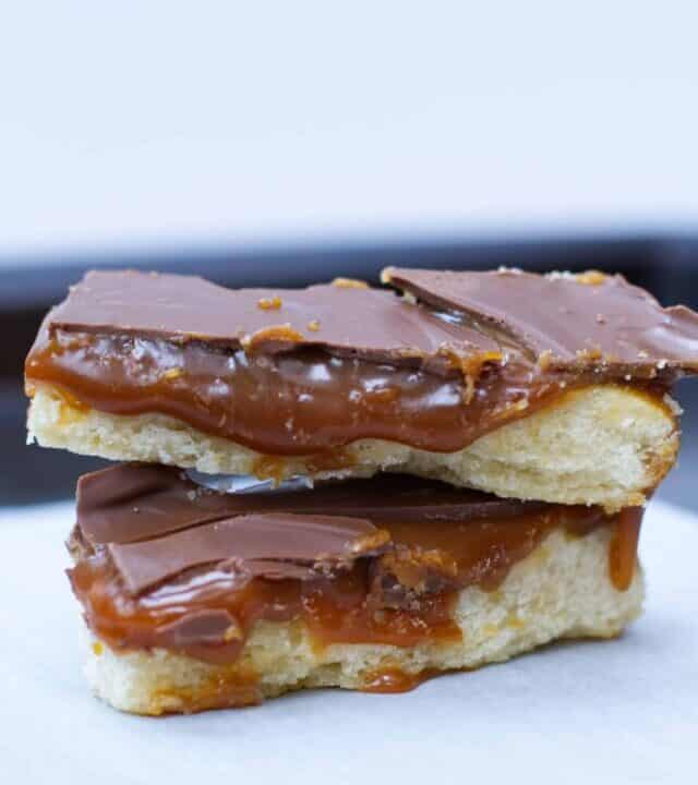 Homemade Twix Bars | kickassbaker.com #twix #homemade #twixbars #caramel #chocolate #dessertrecipes #dessert #easyrecipes #nutfree #peanutfree #allergyfriendly #bakersofinstagram #bakingrecipes #foodblogger #foodbloggerpro #bakefeed #candybarrecipe #foodphotography #foodphotoblog #foodblogfeed #f52gram #kickassbaker #feedfeedbaking #momblogger