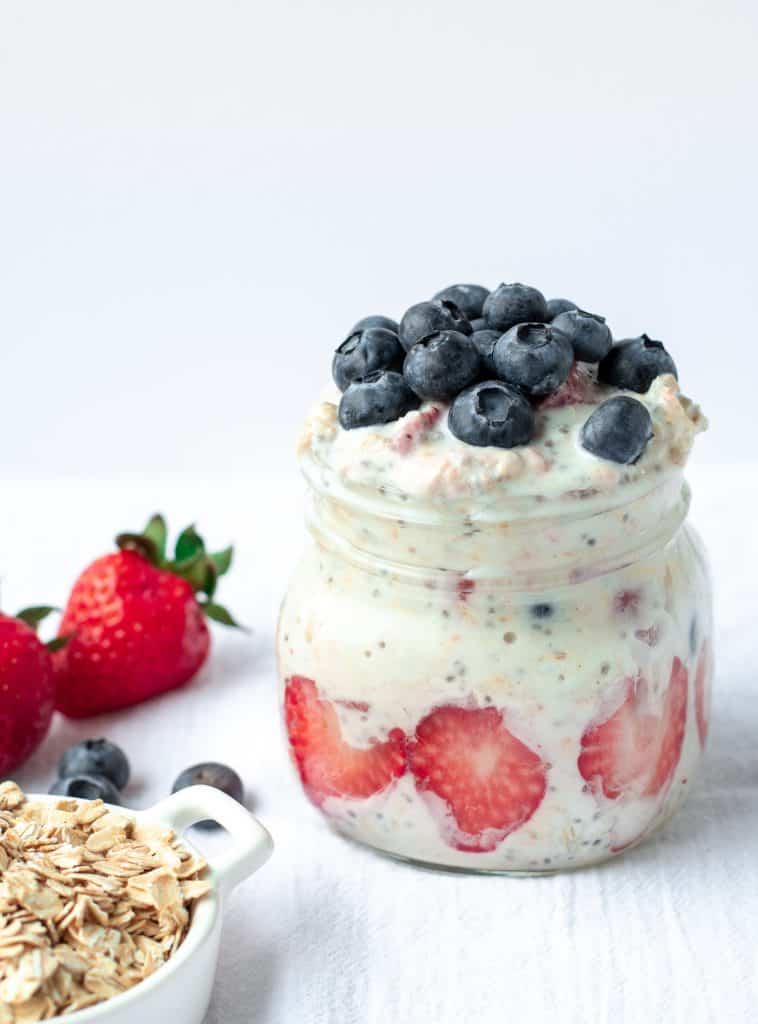 My Husband's Overnight Oats by kickassbaker.com - large mason jar of overnight oats made with yogurt, oats, maple syrup, fruit, and chia seeds