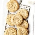 Overhead shot of Soft and Chewy Sugar Cookies on a cooling rack with a glass of milk behind