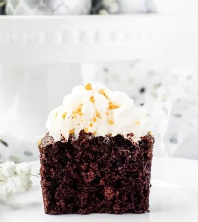 Chocolate Sour Cream Fudge Cupcakes single cupcake cut in half straight on | kickassbaker.com