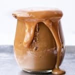 Easy Homemade Dulce de Leche | kickassbaker.com overflowing jar of smooth caramel
