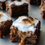 Caramal S'mores bar with toasted marshmallow and caramel dripping down the side of the bar