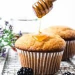 Corn muffins being drizzled with honey