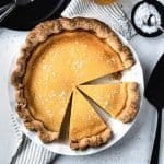 Overhead image of salted honey pie with slices cut from it