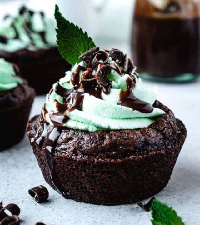 chocolate mint brownie cups with chocolate shavings and chocolate ganache as garnish