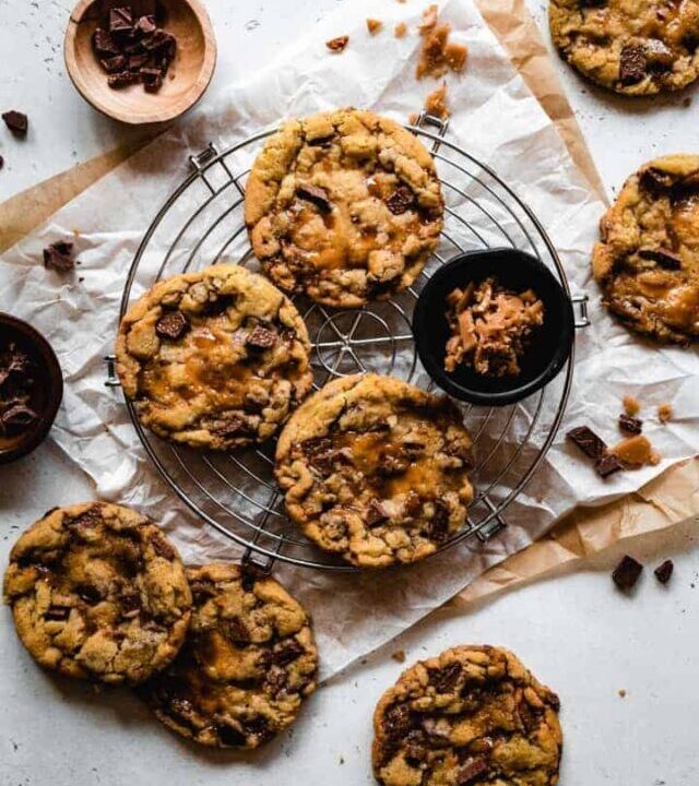 milk chocolate chip cookies with toffee on a round cooling rack