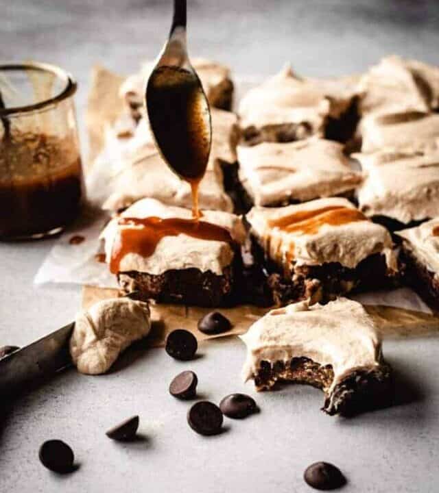 frosted blondies getting drizzled with salted caramel sauce