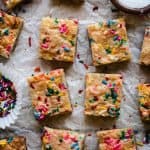 sugar cookie bars with funfetti sprinkles on a piece of parchment paper