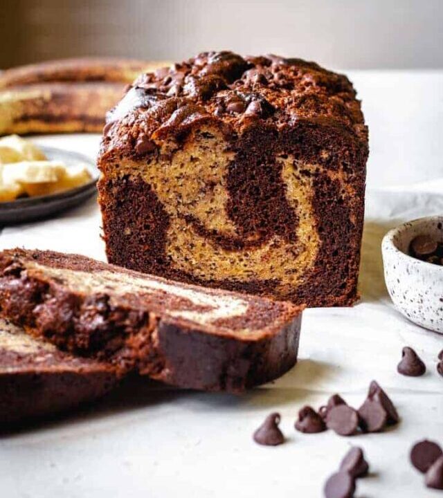 marbled chocolate banana bread slices with chocolate chips in front