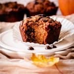 pumpkin muffin on a plate with a bite taken out