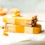 Make a batch of these delicious, creamy orange flavored creamsicles with a layer of crunchy graham cracker crumbles.