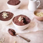 Dark chocolate mousse made using cocoa powder with a spoonful taken out.