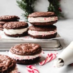 Brownie cookies filled with peppermint filling and sprinkled with crushed candy canes.