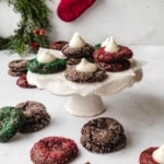 Festive chocolate thumbprint cookies filled with peppermint schnapps filling on a cake stand.