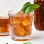 Glass of mint iced tea made using tea bags.