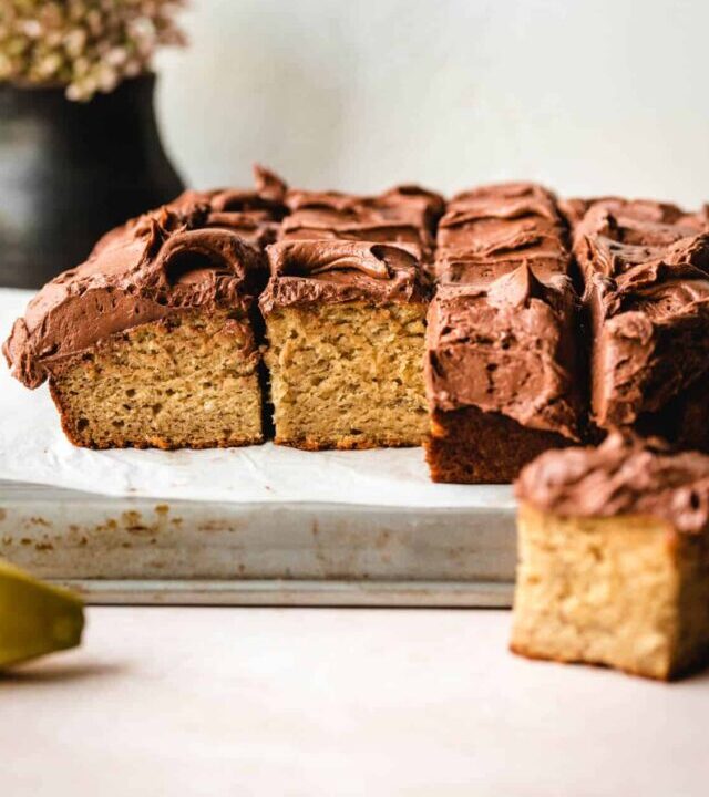 Snack sized cut pieces of banana cake with chocolate frosting.