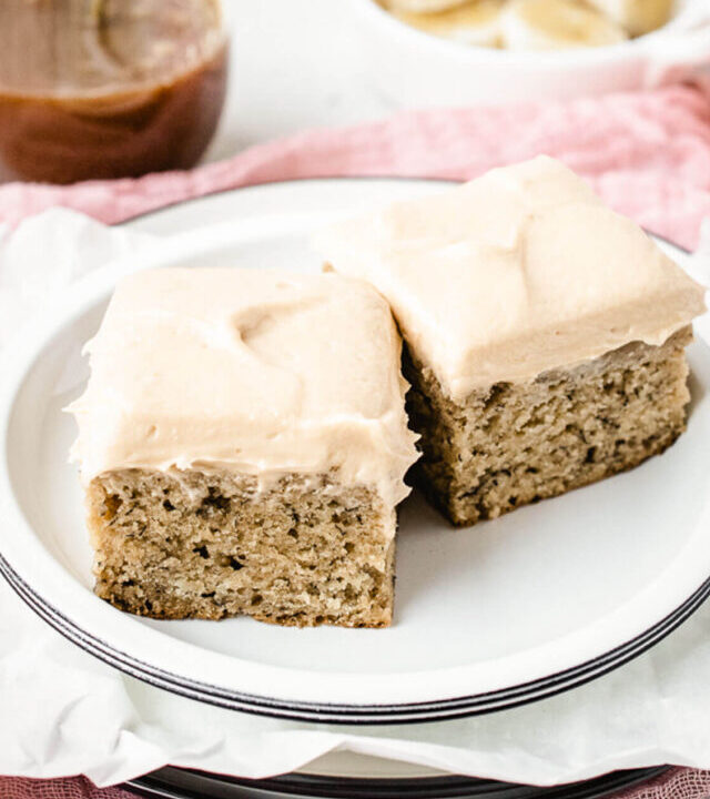 Two square pieces of banana cake on a plate.