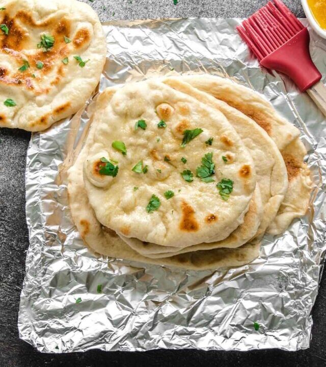 Garlic butter spread over pita bread.