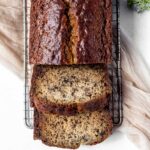 Sour cream banana bread sliced and served on a cooling rack.