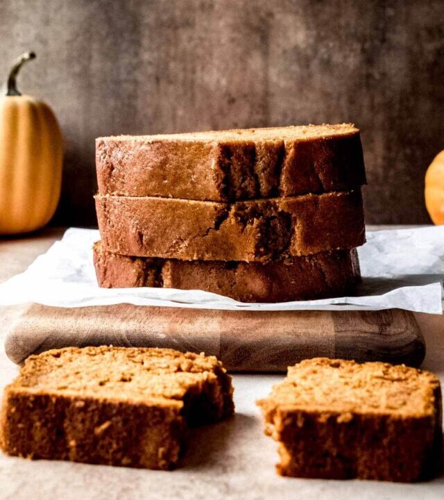 Large stack of pumpkin bread.