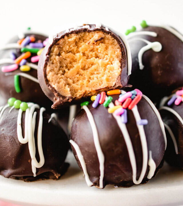 Golden Oreo truffle with a bite taken out.