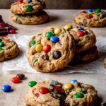 Chocolate chip M&M cookies stacked together.