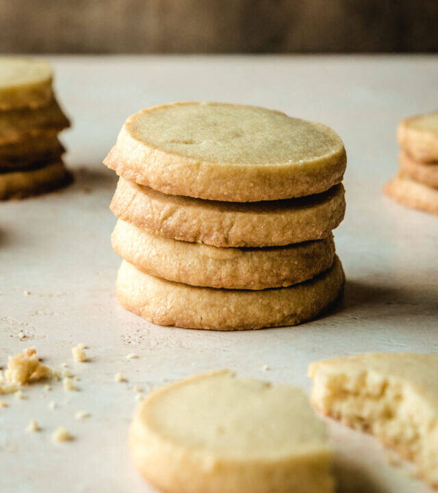 Stack of four round shortbread cookies.