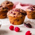 Bakery-style raspberry jam muffins with sour cream.