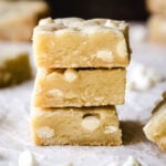 Stack of 3 fudgy white chocolate brownies.