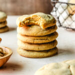 Stack of chewy brown butter cookies with a bite taken out of the top one.