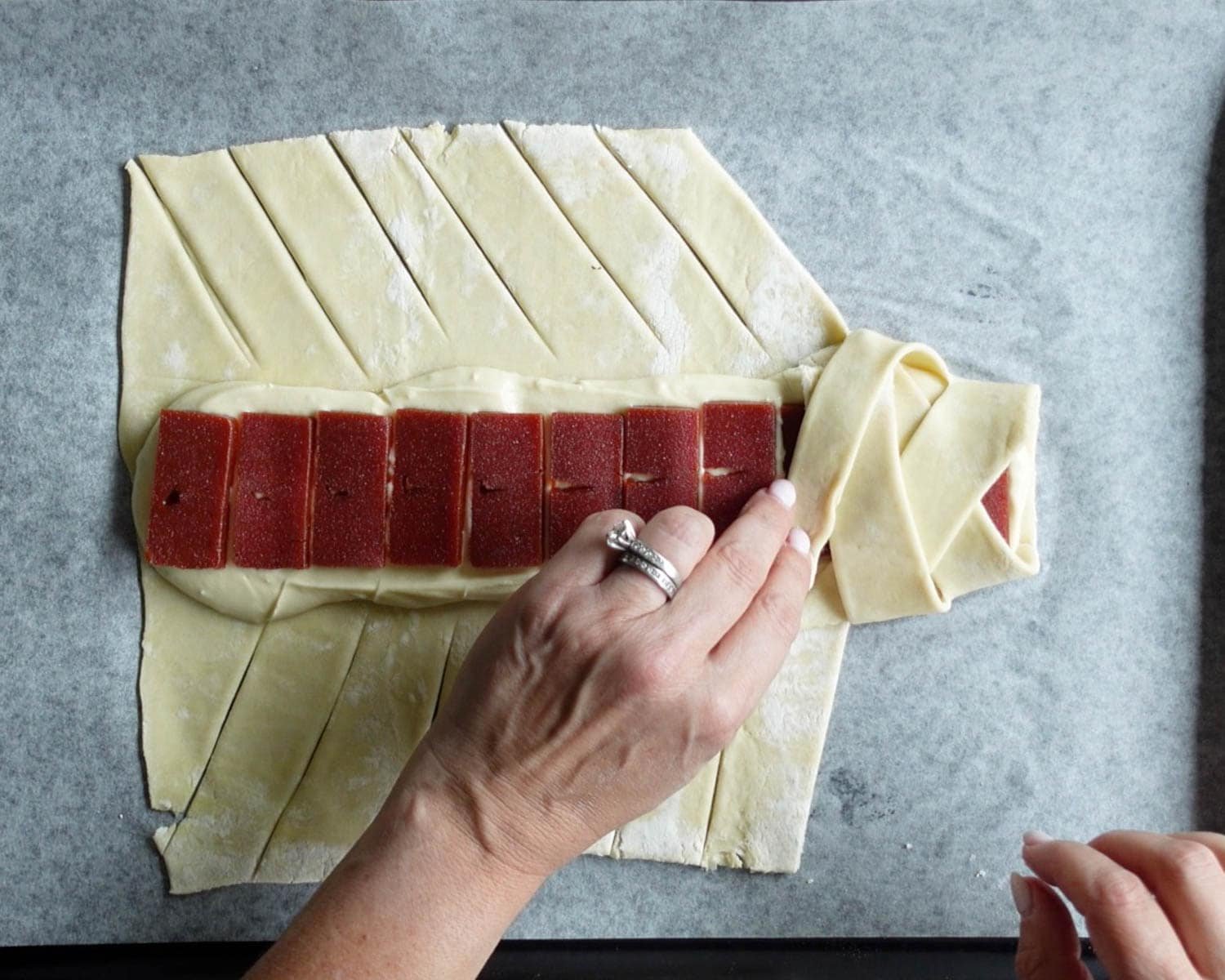 Fold strips of puff pastry over top of the filling alternating sides to create a braid.