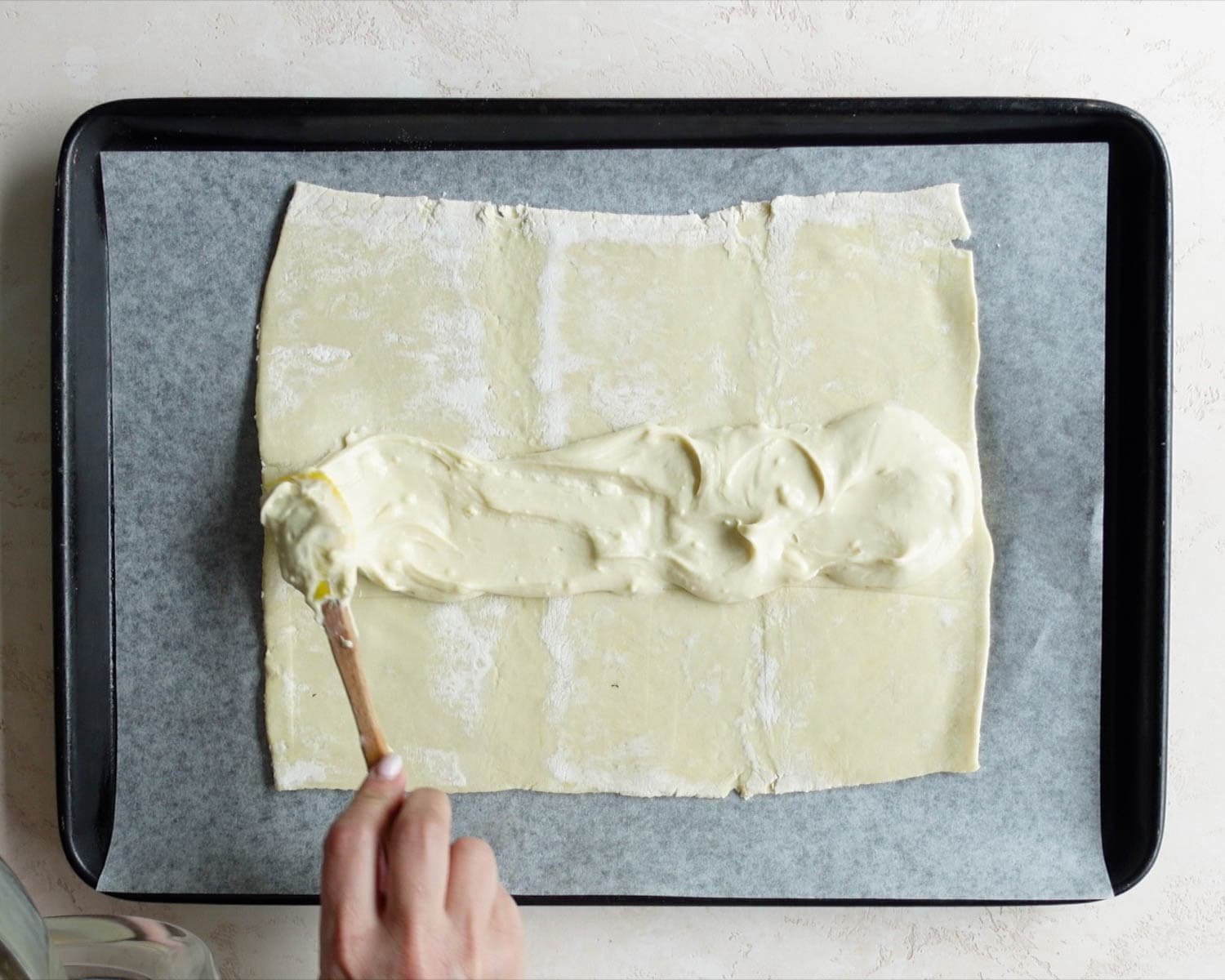 Spread half the cream cheese mixture down the middle of the puff pastry.