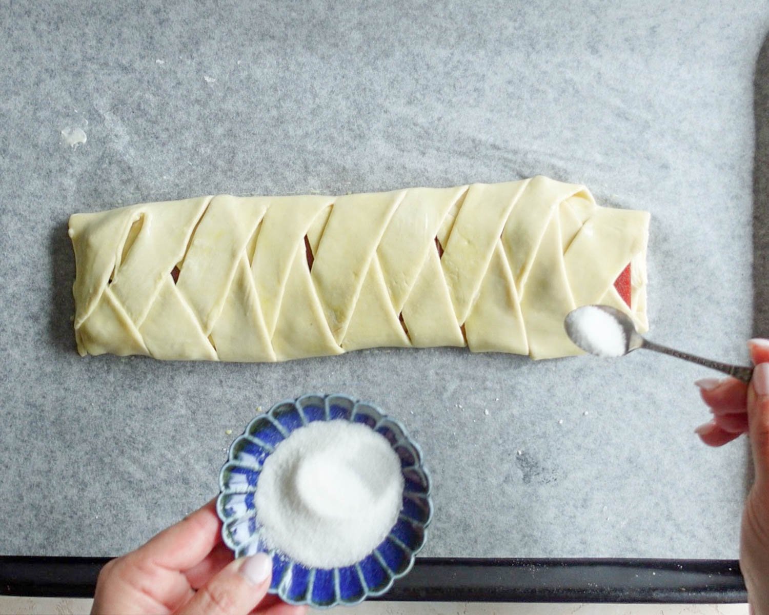 Sprinkle granulated sugar over top of the braided puff pastry.