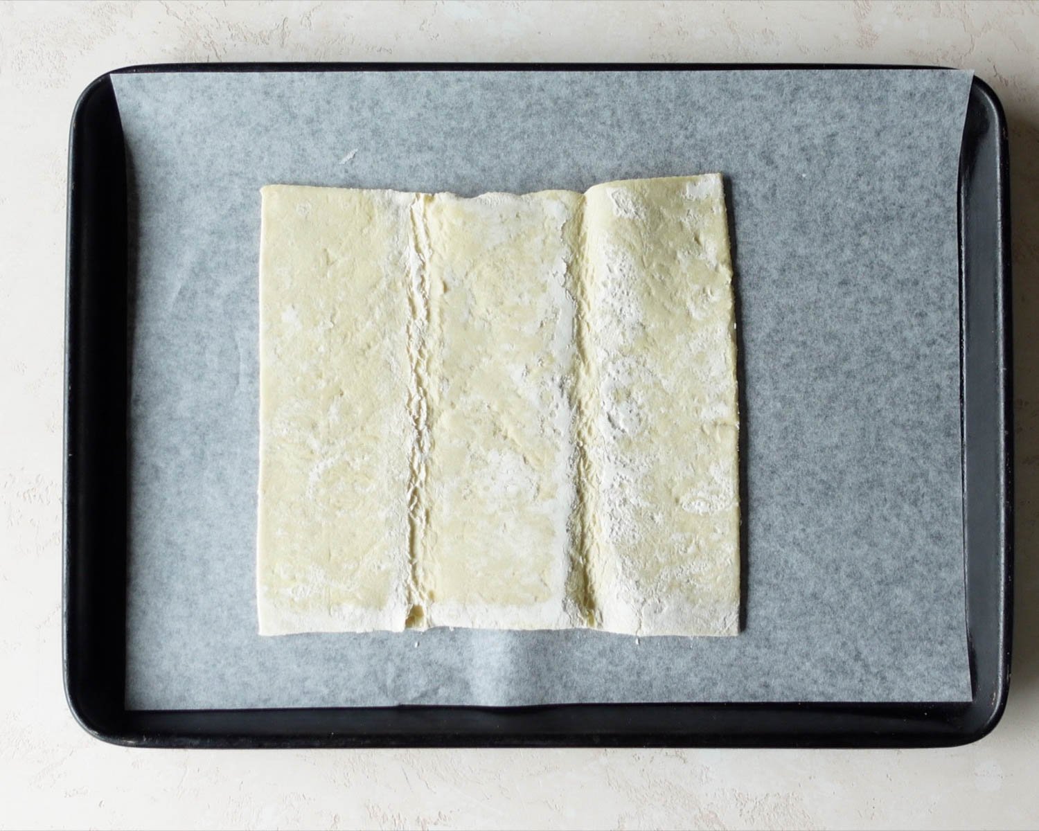 Unfold the thawed puff pastry onto a parchment lined baking sheet.