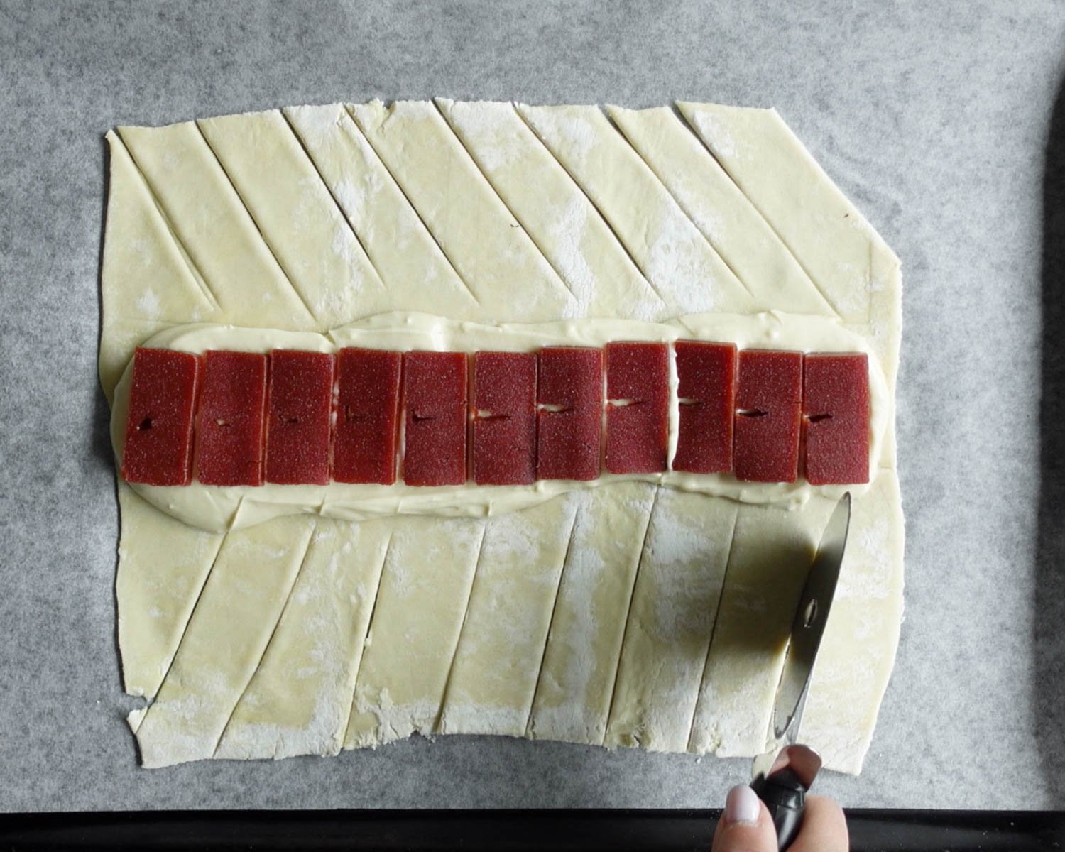 Use a sharp knife or pizza wheel to cut 1-inch thick strips of pastry on both sides of the filling.
