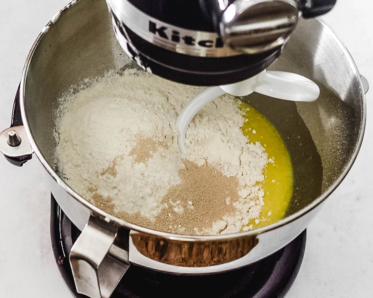 Add tangzhong (flour paste), flour, yeast, water, oil, eggs, yolks to the bowl of a stand mixer to make the challah dough.