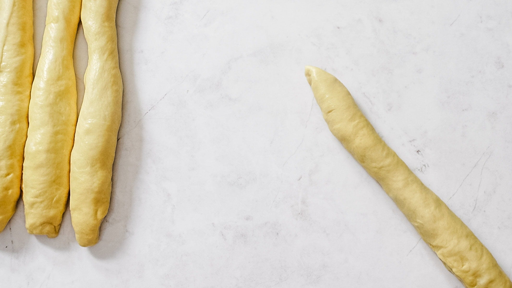 Divide dough into four equal pieces and shape into long ropes.