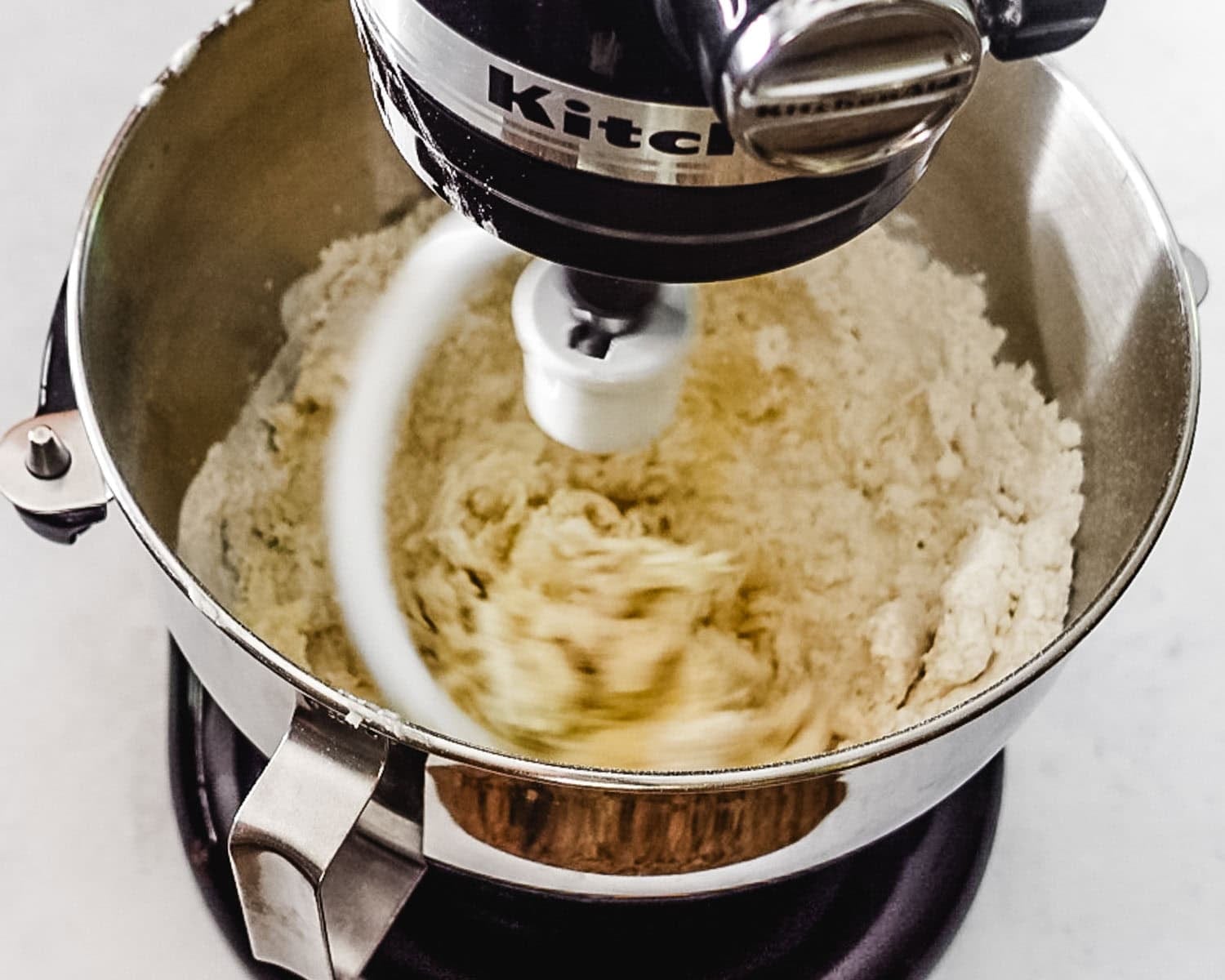 Mix the ingredients with a dough hook until they come together in a ball.